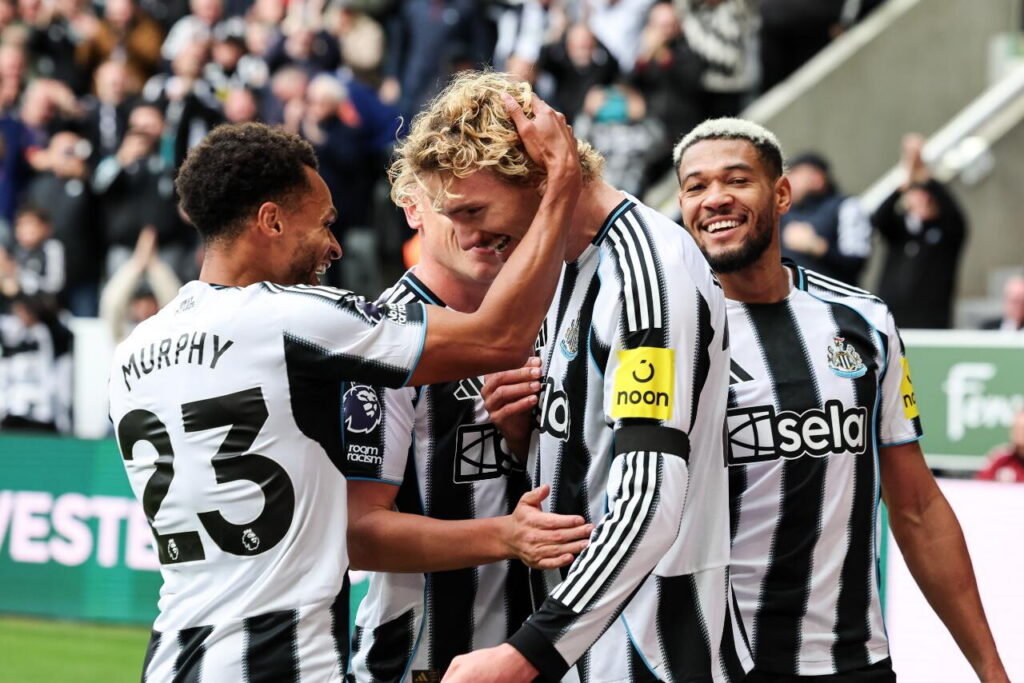 Newcastle players celebrate during Premier League match